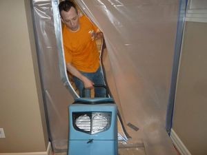 Technician Setting Up A Vapor Barrier In A Commercial Property